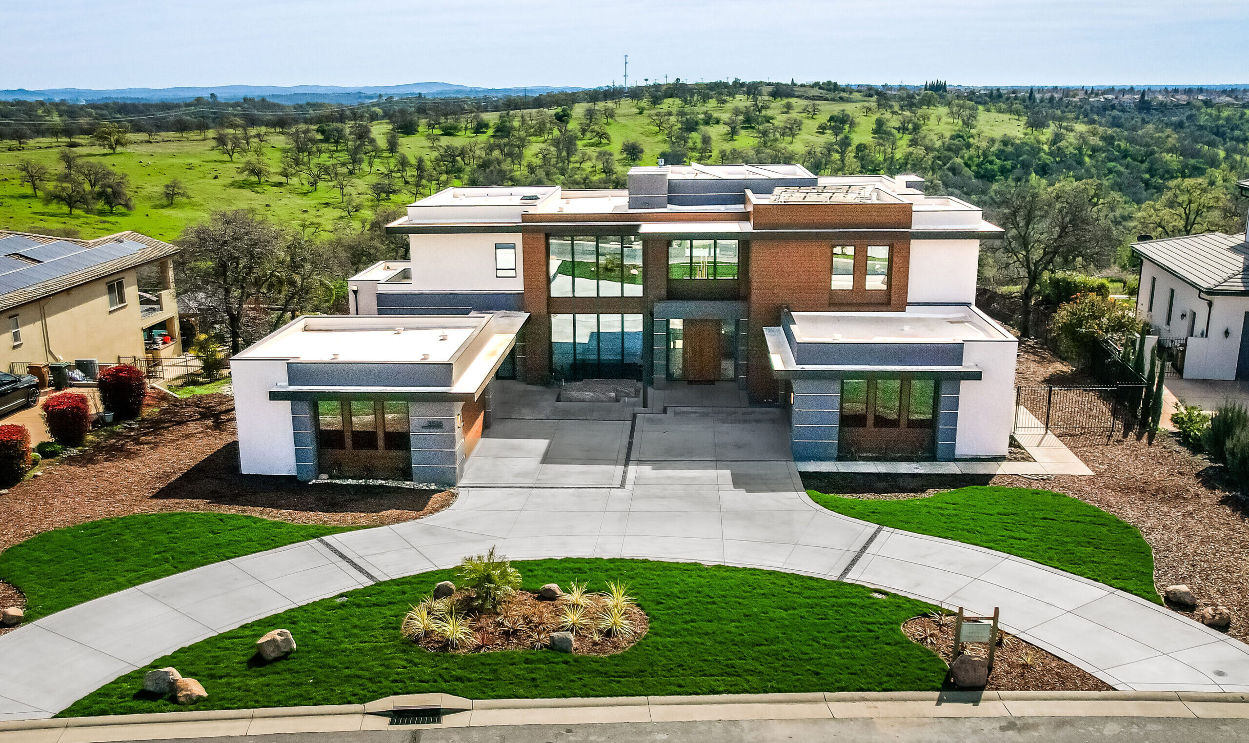 An aerial view of a home with a large front yard.